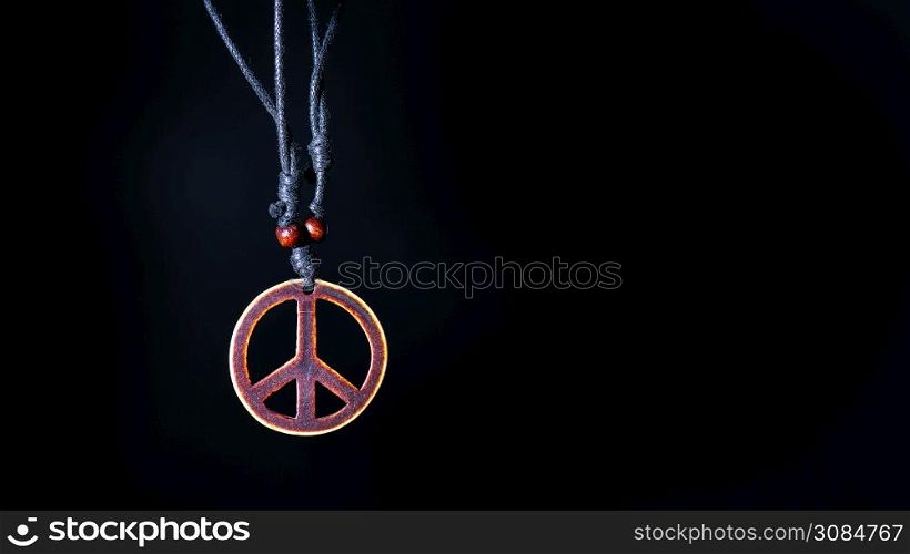 Wooden peace symbol attached to string necklace fairies love not war.
