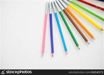 Wooden Pencil Colours are putting on wooden white table