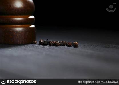 Wooden peppermill with peppercorns