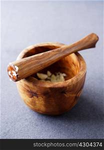 Wooden pestle and mortar with crushed garlic