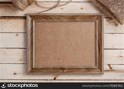 wooden photo frames on light wooden background with canvas