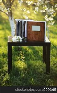 wooden photobook on the table. two wooden photo books on the table in the nature. place for the inscription