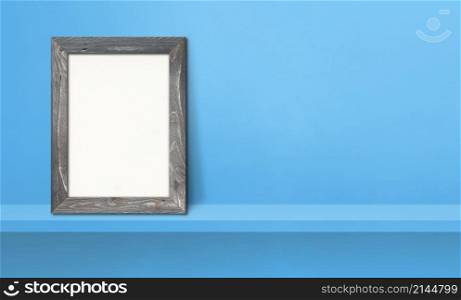Wooden picture frame leaning on a blue shelf. 3d illustration. Blank mockup template. Horizontal banner. Wooden picture frame leaning on a blue shelf. 3d illustration. Horizontal banner