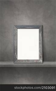 Wooden picture frame leaning on a grey shelf. 3d illustration. Blank mockup template. Vertical background. Wooden picture frame leaning on a grey shelf. 3d illustration. Vertical background