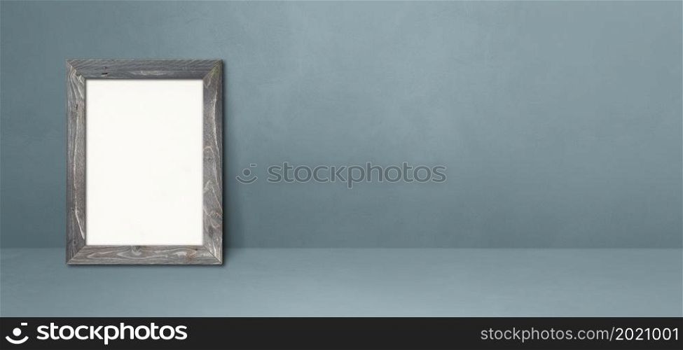 Wooden picture frame leaning on a grey wall. Blank mockup template. Horizontal banner. Wooden picture frame leaning on a grey wall. Horizontal banner