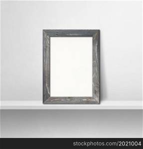 Wooden picture frame leaning on a white shelf. 3d illustration. Blank mockup template. Square background. Wooden picture frame leaning on a white shelf. 3d illustration. Square background