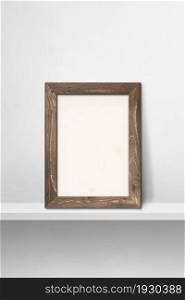 Wooden picture frame leaning on a white shelf. 3d illustration. Blank mockup template. Vertical background. Wooden picture frame leaning on a white shelf. 3d illustration. Vertical background