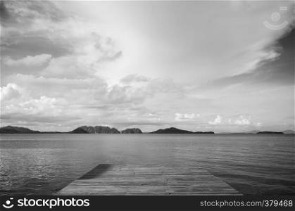 Wooden pier and calm andaman sea with islands view in summer at Koh lanta, Krabi, Thailand. Black and white image.