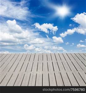 wooden pier and sky with white clouds. pier over clouds