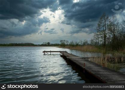 Wooden pier in a lake and cloudy sky, Stankow, Poland
