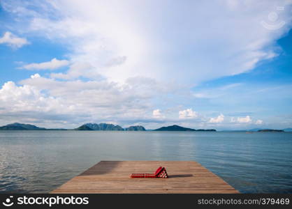 Wooden pier with Thai futon and triangle pillow, calmpeaceful andaman sea with islands view in summer at Koh lanta, Krabi, Thailand. Black and white image.