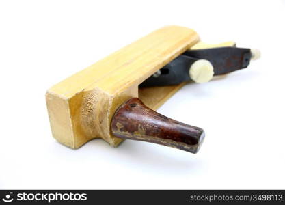 Wooden plane, boards and a shaving on a white background