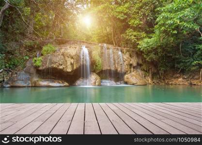 Wooden plank and background with Waterfall in Erawan Park