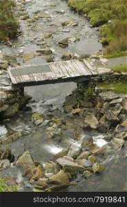 Wooden plank topped bridge, crossing mountain stream. Cwmorthin, Tanygriseau, Blaenau Ffestiniog, Wales, United Kingdom, Europe
