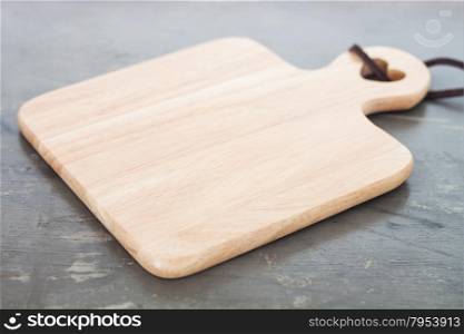 Wooden plate on gray background, stock photo