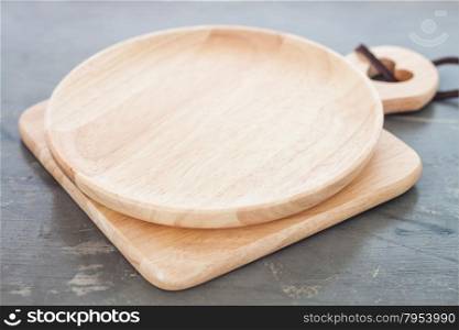 Wooden plate on gray background, stock photo