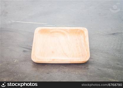 Wooden plate on grey background, stock photo