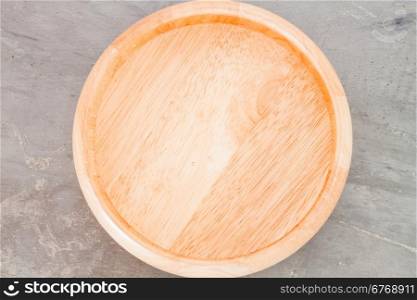 Wooden plate on grey background, stock photo