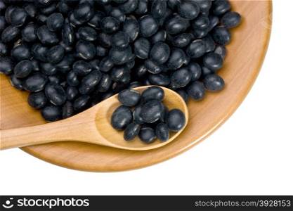 wooden plate with black soy beans on white background with clipping paths