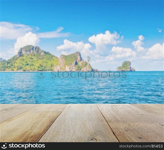 wooden platform with blurred beautiful seascape of chicken island (koh kai) in the andaman sea, off the coast of Krabi, Thailand