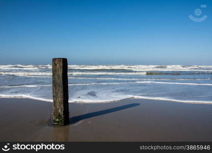 Wooden pole on Dutch beach