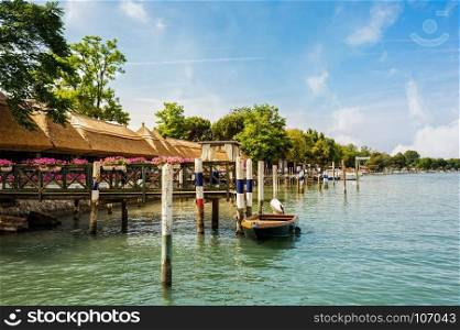 Wooden poles for mooring boats on the sea. Bibione Italy.