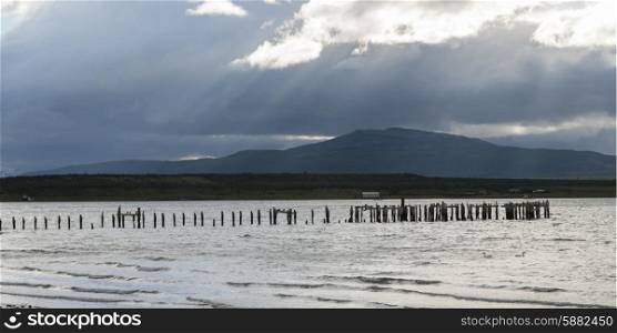 Wooden posts in the Pacific ocean, Puerto Natales, Patagonia, Chile