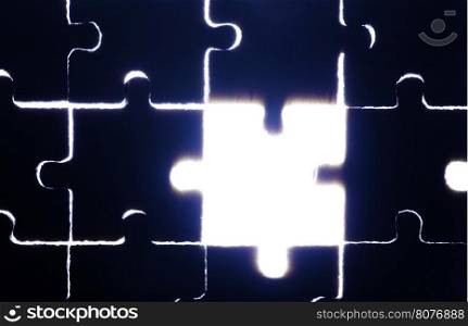 Wooden puzzle and backlight background. Close up. Blue color light