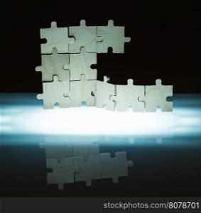 Wooden puzzle and backlight background. Vertically stacked parts.