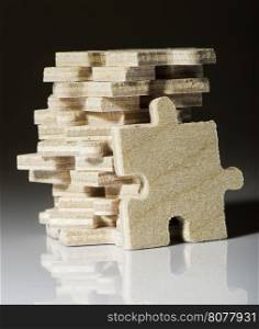 Wooden puzzle on white background. Pile of puzzle