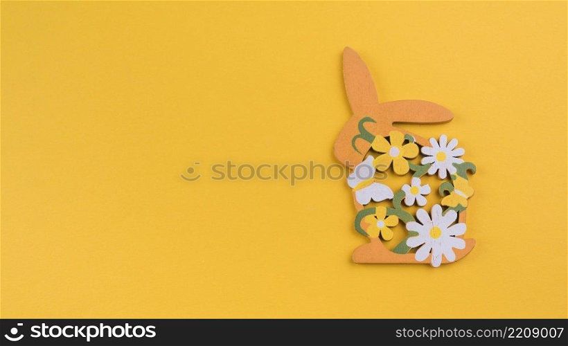 wooden rabbit with flowers yellow table