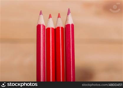 Wooden red pencils, on wooden table