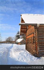 wooden rural house amongst snow