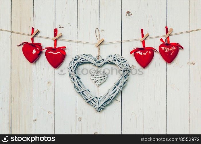 wooden rustic decorative hearts hanging on vintage wooden background with space.