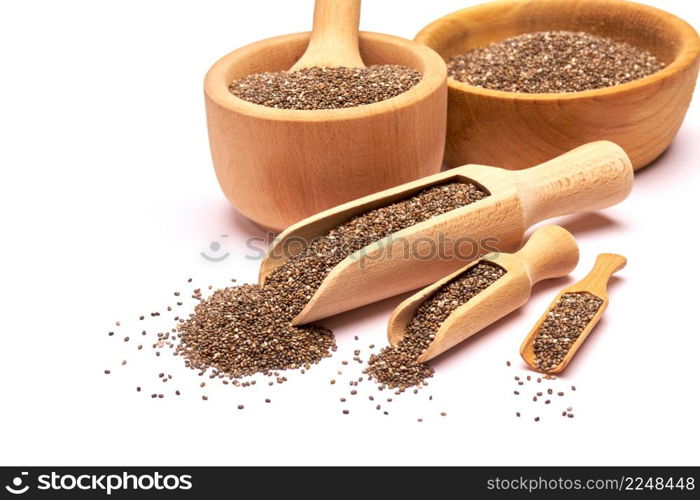 Wooden scoop of organic natural chia seeds close-up isolated on white background. High quality photo. Wooden scoop of organic natural chia seeds close-up isolated on white background