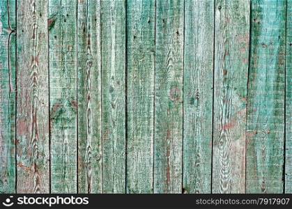 Wooden shabby planked fence background.
