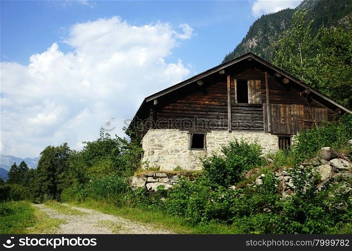 Wooden shed near track in mountain in Switzerland