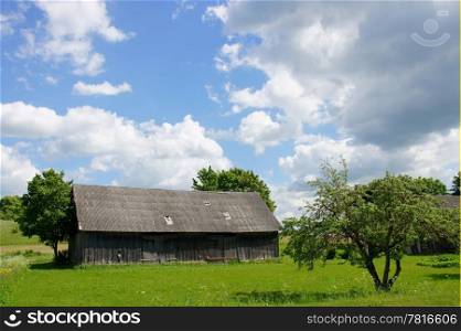 Wooden shed on a background of the cloudy sky