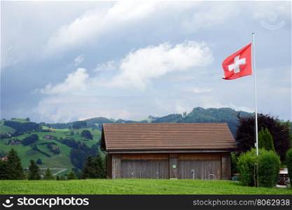 Wooden shed on the green grass in Switzerland