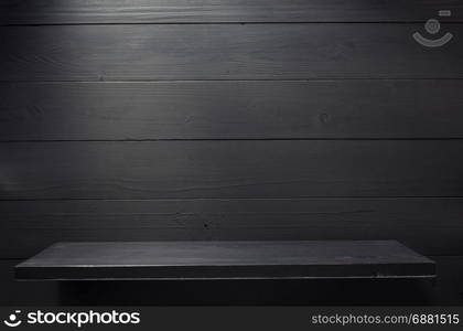 wooden shelf at black background