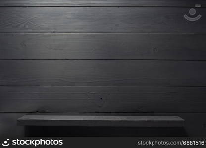 wooden shelf at black background