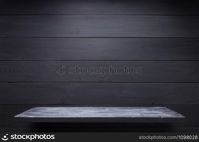 wooden shelf at black background, wall texture surface