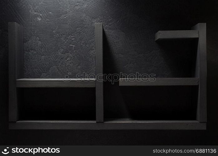 wooden shelf on black wall background