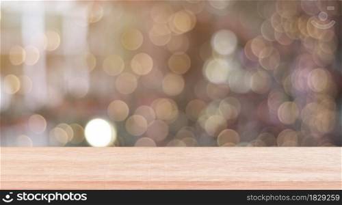 Wooden shelf over blur bokeh light background. Empty wood table top, counter for display product for promotion.