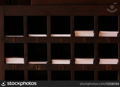 Wooden shelves slots for paper