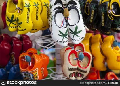 wooden shoes in many colors for sale in amsterdam souvenir shop