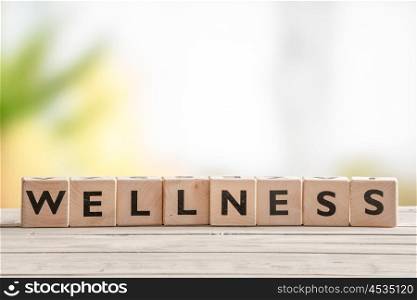 Wooden sign with the word wellness on a table