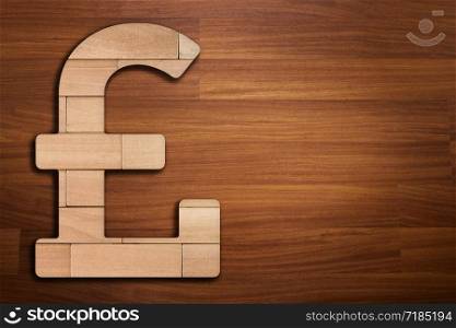 Wooden silhouette of UK pound currency sign