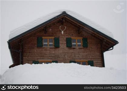 Wooden skiing hut covered with a lot of fresh snow in Montafon, Austria