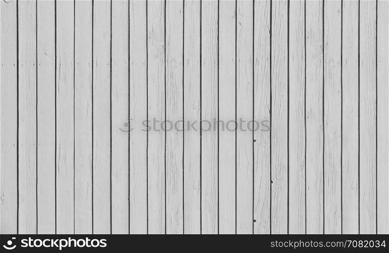 Wooden slat fence with parallel planks with white paint.. Wooden fence with parallel planks with white paint.
